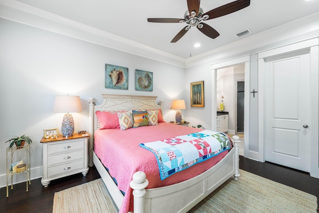 bedroom featuring dark hardwood / wood-style flooring, connected bathroom, crown molding, and ceiling fan