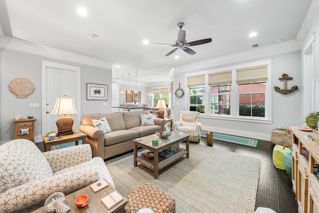 living room featuring dark hardwood / wood-style flooring, crown molding, and ceiling fan