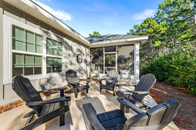 view of patio featuring a sunroom