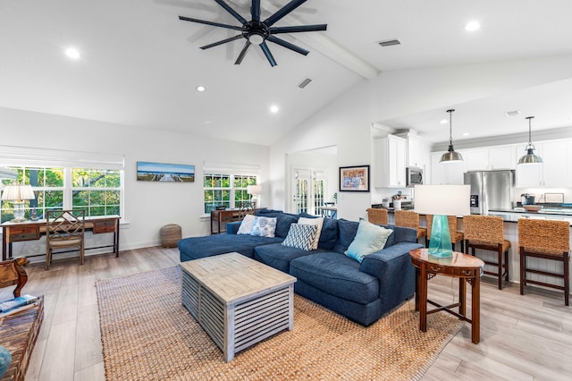 living room featuring beamed ceiling, ceiling fan, high vaulted ceiling, and light hardwood / wood-style flooring