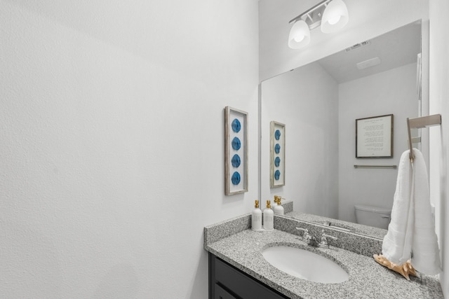 bathroom with vanity and toilet