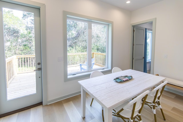 dining space with a wealth of natural light and light hardwood / wood-style flooring