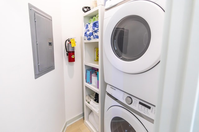 washroom with stacked washer and dryer and electric panel