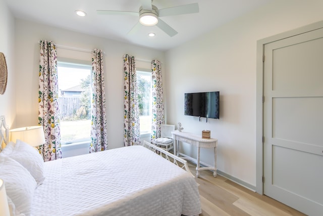 bedroom with light hardwood / wood-style floors and ceiling fan