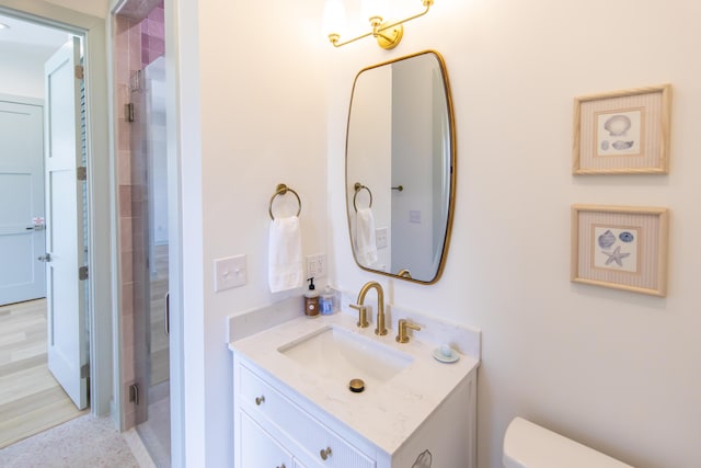 bathroom with vanity, toilet, and walk in shower