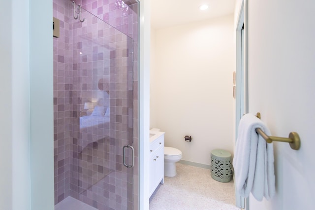 bathroom featuring an enclosed shower, vanity, and toilet