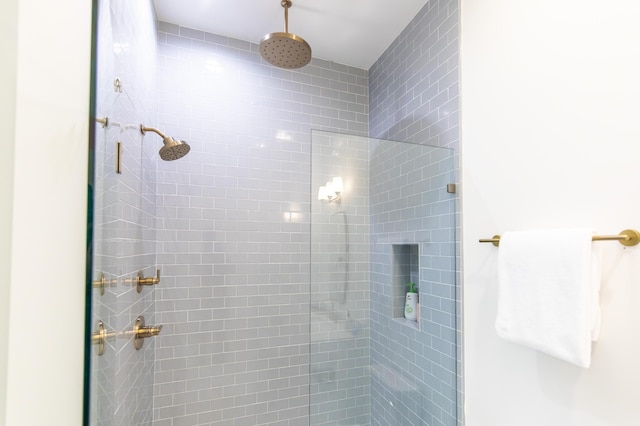 bathroom with a tile shower