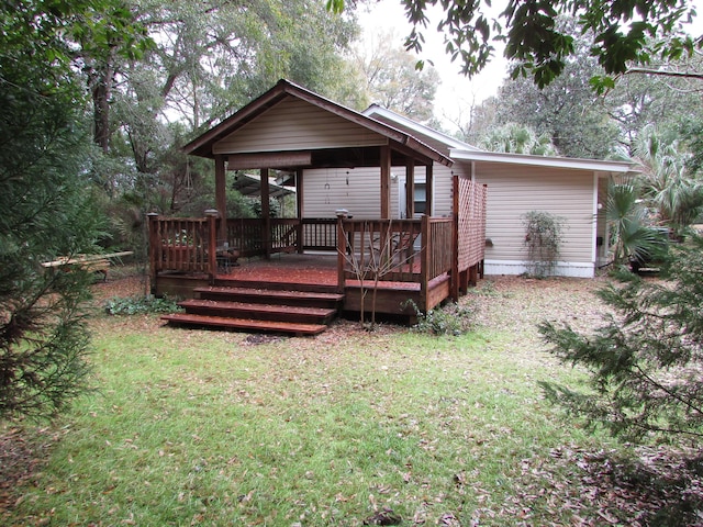 back of house with a yard and a deck