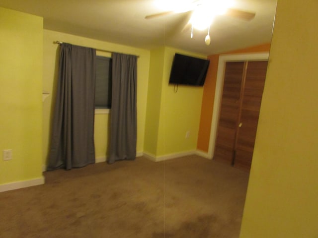 empty room with carpet floors and ceiling fan