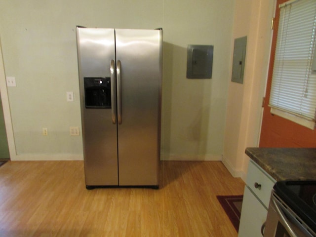 kitchen featuring electric panel, light wood-type flooring, and stainless steel fridge with ice dispenser