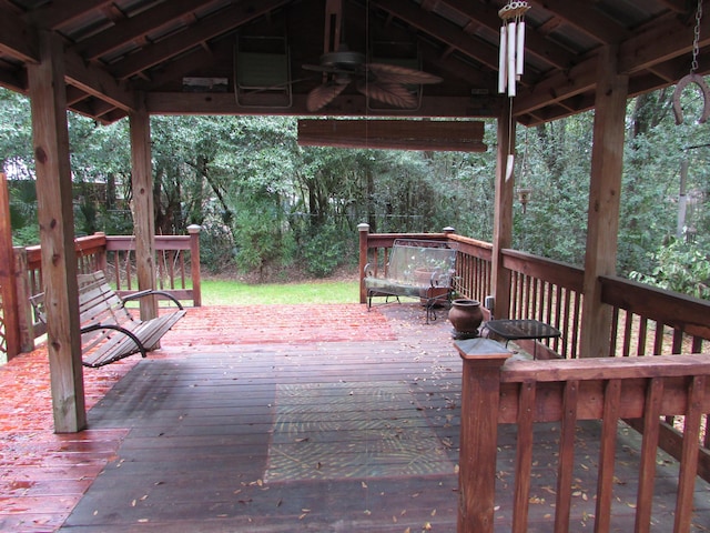 wooden deck featuring ceiling fan