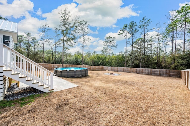 view of yard with a fenced in pool