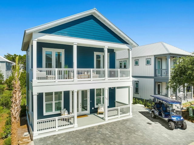 rear view of property featuring covered porch