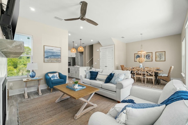 living room featuring ceiling fan and light wood-type flooring