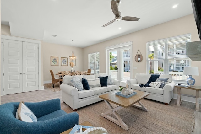 living room with ceiling fan and light wood-type flooring