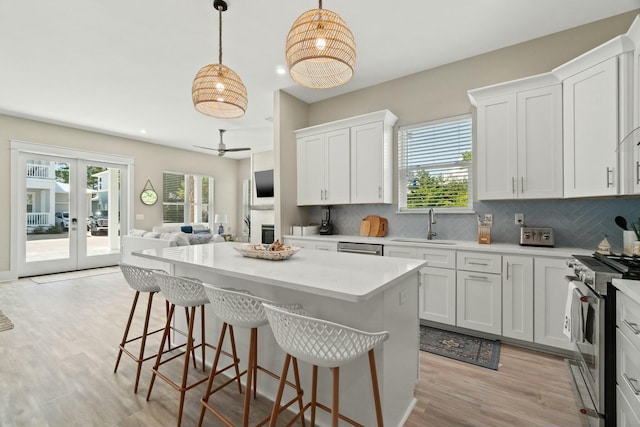 kitchen with appliances with stainless steel finishes, white cabinets, and french doors