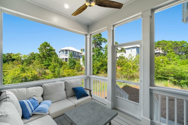 sunroom / solarium featuring plenty of natural light and ceiling fan