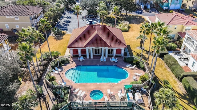 view of swimming pool featuring a patio and a community hot tub