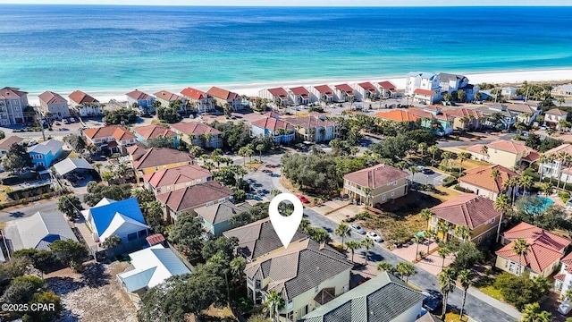 birds eye view of property with a view of the beach and a water view