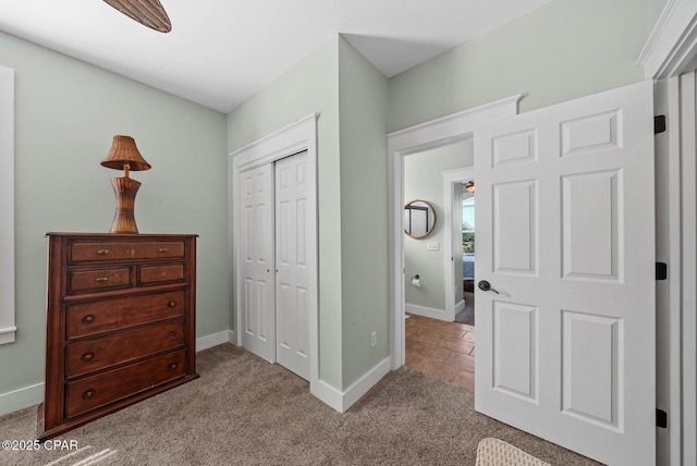 carpeted bedroom featuring ceiling fan and a closet