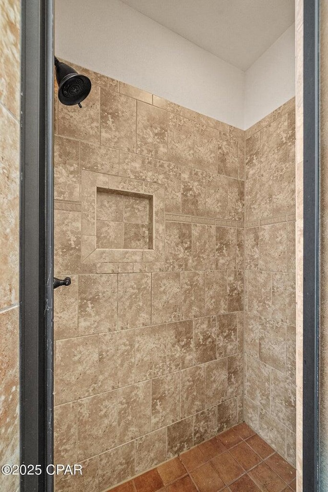 bathroom with a tile shower