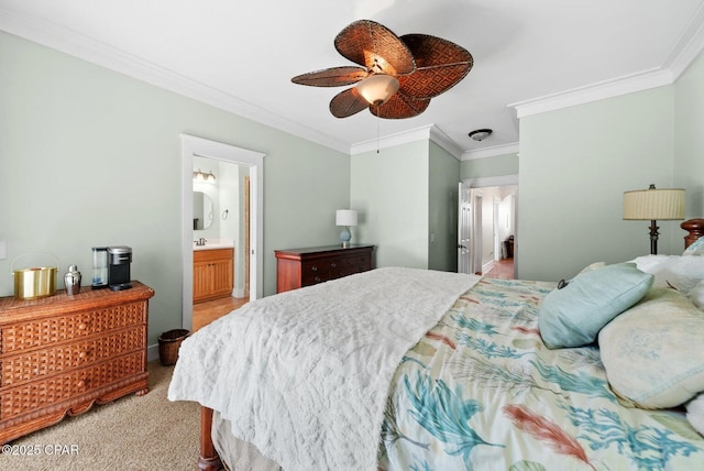 carpeted bedroom featuring crown molding, ceiling fan, and ensuite bathroom