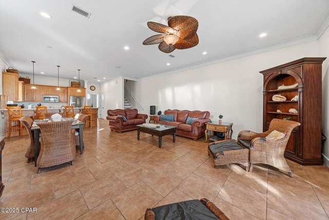 living room with crown molding and ceiling fan