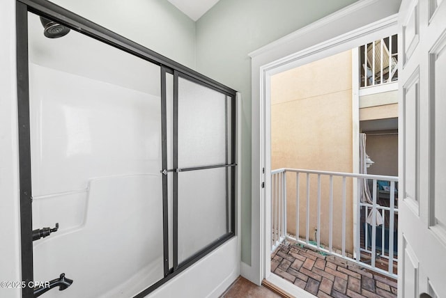 bathroom with shower / bath combination with glass door