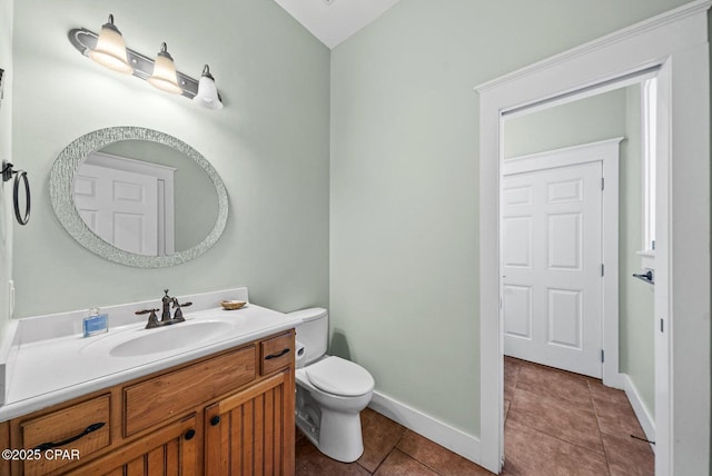 bathroom featuring vanity, tile patterned floors, and toilet