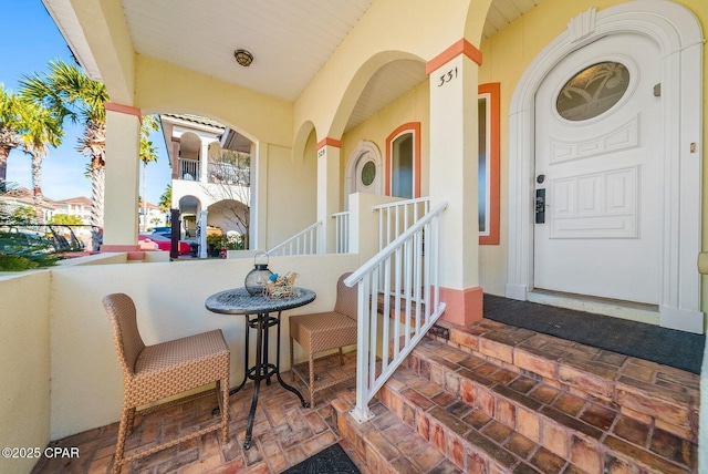 view of exterior entry with a porch