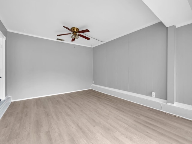 unfurnished room with crown molding, ceiling fan, and light hardwood / wood-style floors