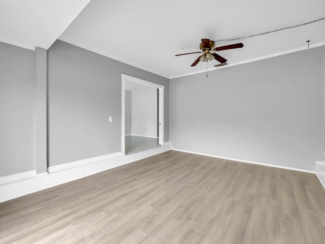 spare room featuring crown molding, ceiling fan, and light hardwood / wood-style flooring