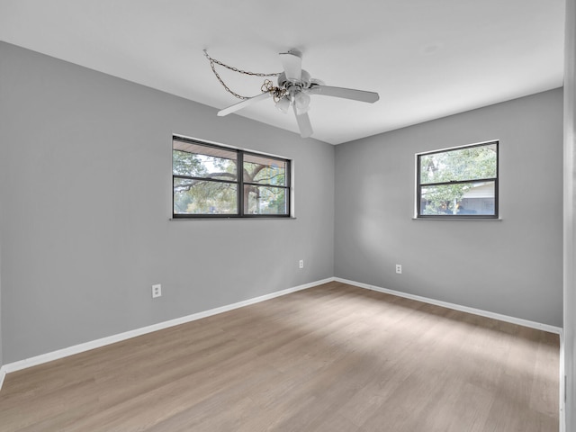 spare room featuring ceiling fan and light hardwood / wood-style flooring