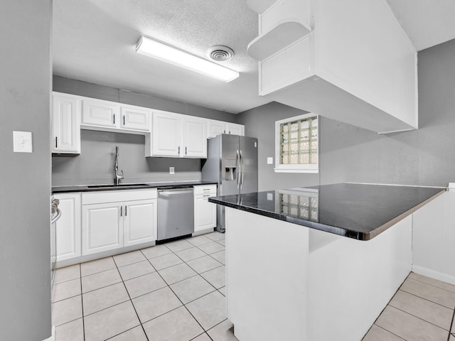 kitchen featuring white cabinetry, appliances with stainless steel finishes, sink, and kitchen peninsula