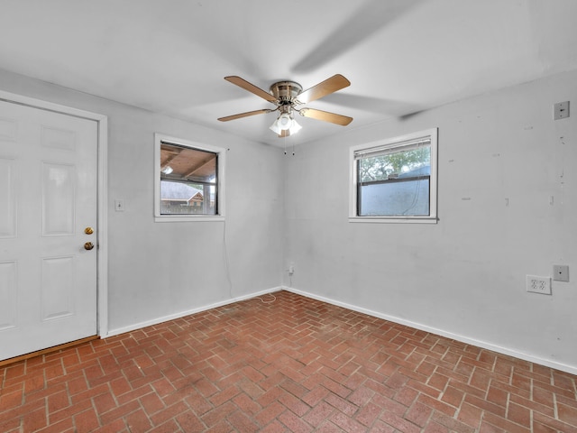 unfurnished room with ceiling fan and a healthy amount of sunlight