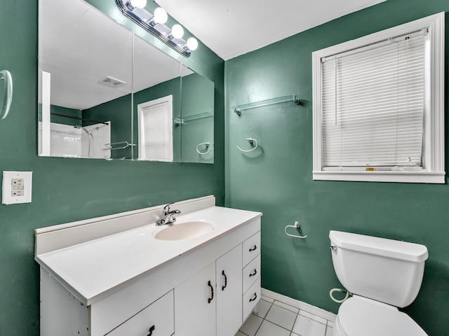 bathroom with walk in shower, tile patterned floors, vanity, and toilet