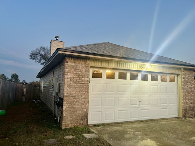 view of garage at dusk