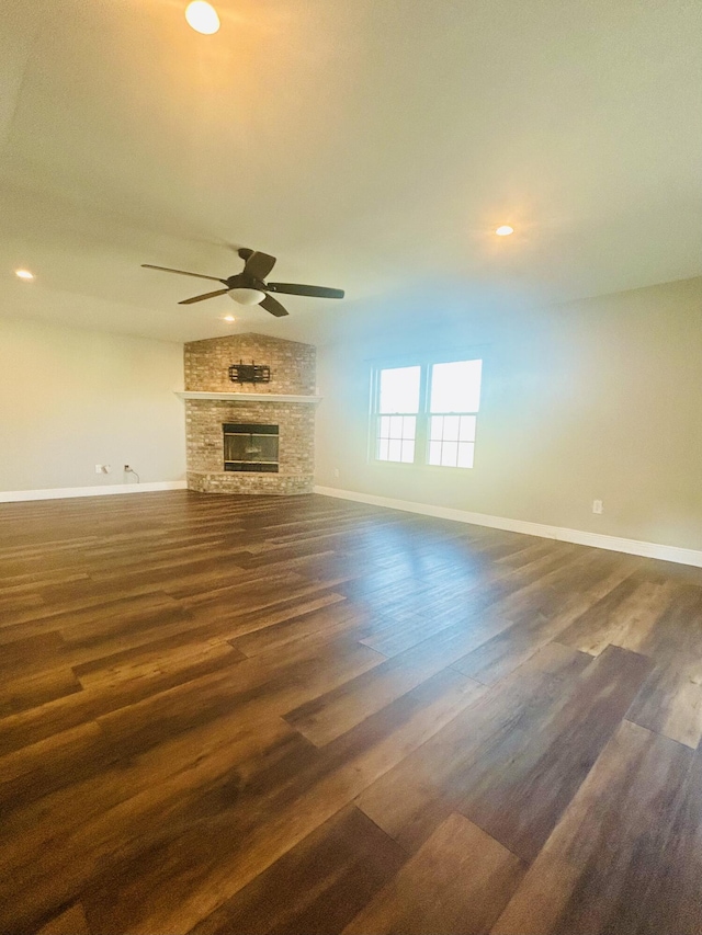 545 J H Crews Cir, Panama City, FL 32404 - unfurnished living room with a ceiling fan, a fireplace, dark wood finished floors, baseboards, and recessed lighting