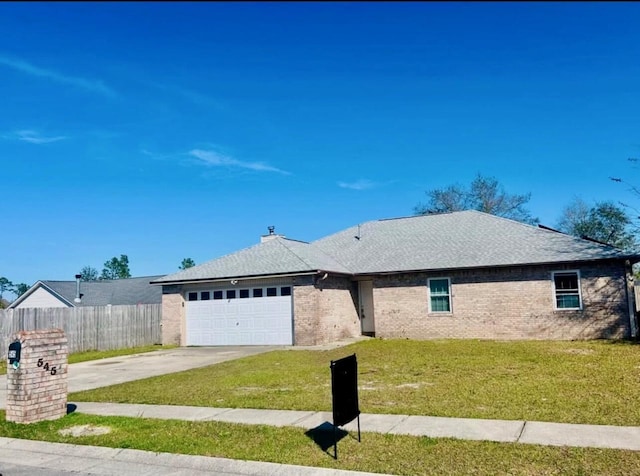 545 J H Crews Cir, Panama City, FL 32404 - ranch-style home with driveway, fence, a garage, brick siding, and a front yard
