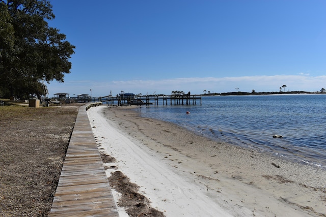 dock area with a view of the beach and a water view