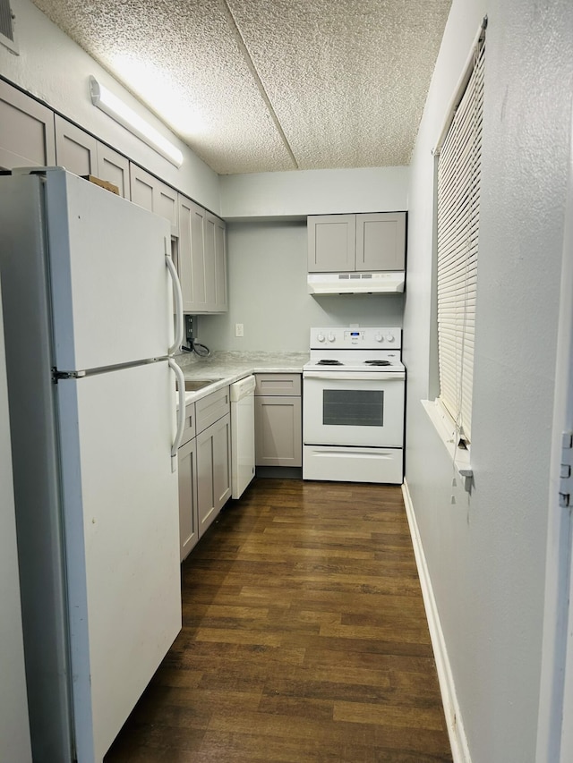 kitchen featuring gray cabinets, dark hardwood / wood-style floors, a textured ceiling, and white appliances