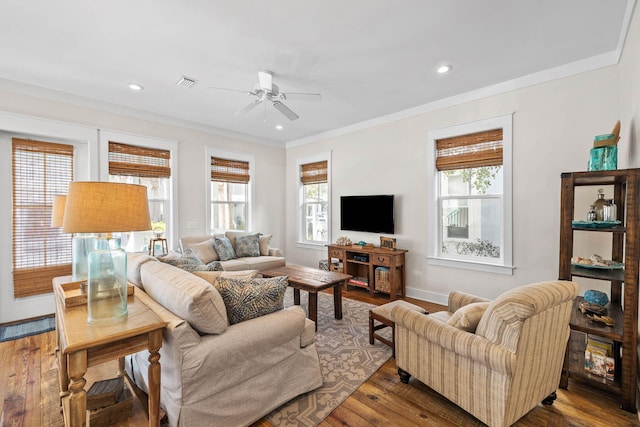 living room featuring ceiling fan, ornamental molding, a healthy amount of sunlight, and hardwood / wood-style floors