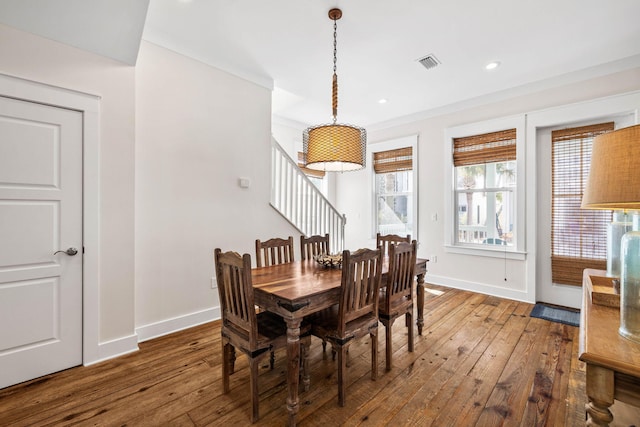 dining room featuring dark wood-type flooring and crown molding