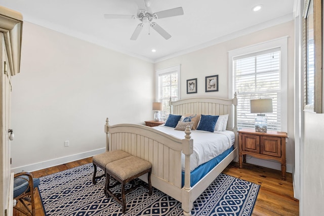 bedroom with ceiling fan, ornamental molding, and wood-type flooring