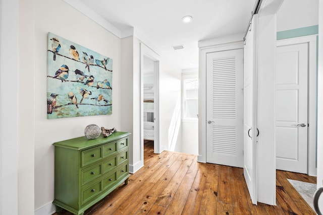 hallway with hardwood / wood-style floors