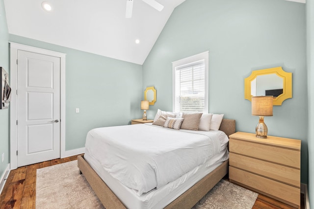 bedroom with high vaulted ceiling, dark wood-type flooring, and ceiling fan