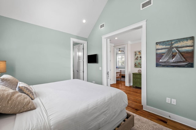 bedroom featuring wood-type flooring and high vaulted ceiling