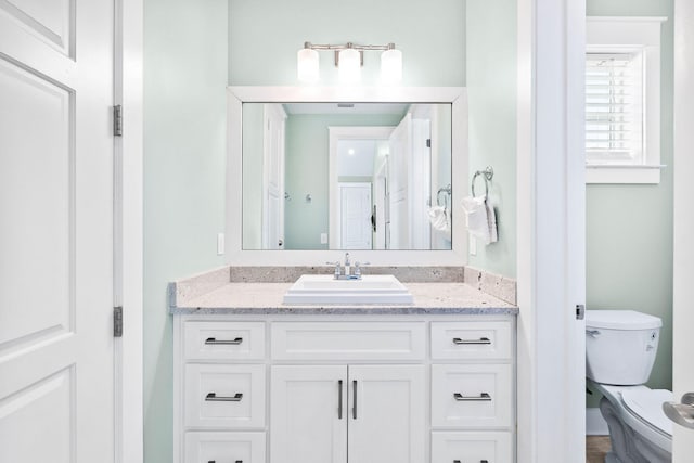 bathroom with vanity and toilet