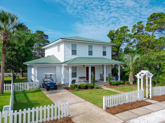 view of front of home with a porch, a garage, and a front lawn