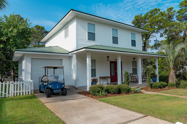 view of front of property featuring a porch, a garage, and a front yard